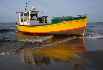 Naklejka na ściany i meble Wooden fishing boat on the beach of Baltic Sea in Sopot/Poland in sunny summer day. 