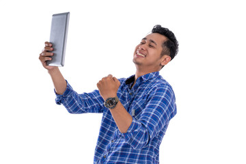 portrait of asian young man happy looking screen tab with isolated