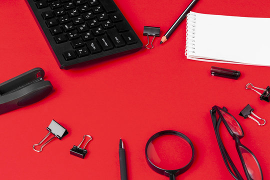 Set Of Stationery Items On Red Office Desk