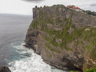 The beauty of the ocean. Ocean waves lapping against the cliff and the formation of white foam.