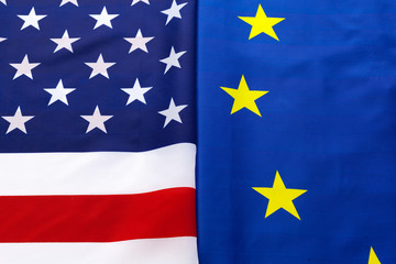 Closeup of Flags of USA and European Union lying together on table