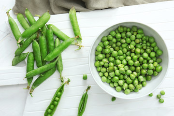 Bowl with tasty fresh peas on table