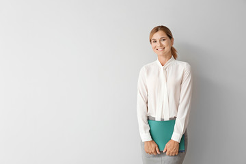 Beautiful female teacher on light background