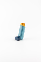 Salbutamol inhaler with cigarettes on white background  ( Asthma is not compatible with tobacco) 