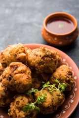 rava Bhajj or bhajiya also known as suji Pakoda or semolina Pakora, served with tomato ketchup. selective focus