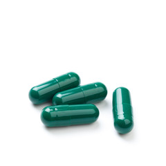 herb capsule with green herbal leaf isolated on white background - Image