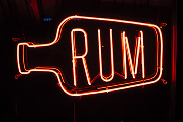 Neon sign in bar with text Rum