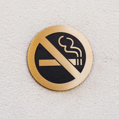 Sign No Smoking on rough white surface
