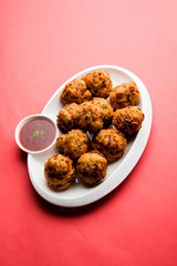rava Bhajj or bhajiya also known as suji Pakoda or semolina Pakora, served with tomato ketchup. selective focus