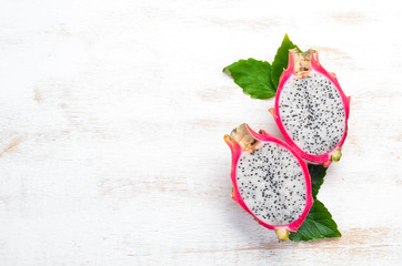 Fruit dragon on a white wooden background. Pitahaya Tropical Fruits. Top view. Free space for text.