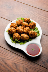 rava Bhajj or bhajiya also known as suji Pakoda or semolina Pakora, served with tomato ketchup. selective focus
