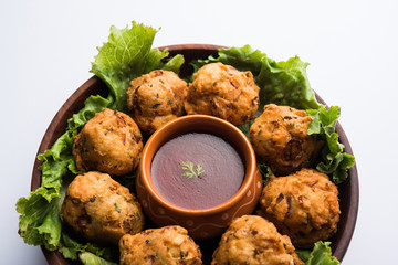 rava Bhajj or bhajiya also known as suji Pakoda or semolina Pakora, served with tomato ketchup. selective focus