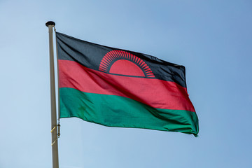 Malawi flag waving against clear blue sky