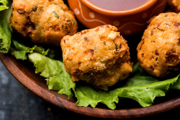 rava Bhajj or bhajiya also known as suji Pakoda or semolina Pakora, served with tomato ketchup. selective focus