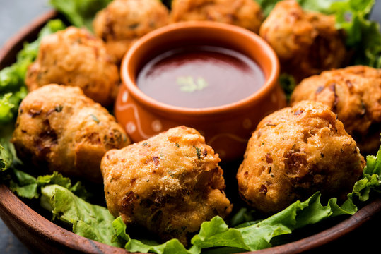 rava Bhajj or bhajiya also known as suji Pakoda or semolina Pakora, served with tomato ketchup. selective focus