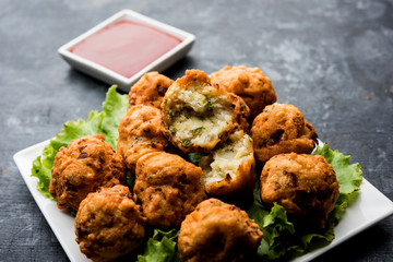 rava Bhajj or bhajiya also known as suji Pakoda or semolina Pakora, served with tomato ketchup. selective focus