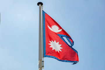 Nepal flag waving against clear blue sky