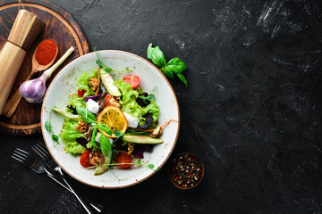 Salad with feta cheese, walnuts and cherry tomatoes. In the plate. Rustic style. Top view. Free space for your text.