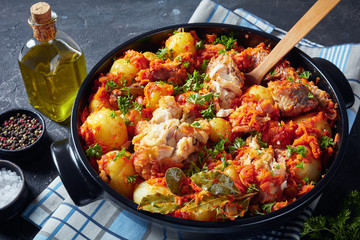 close-up of braised hake in a black pan