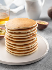 Pancakes stack with butter and honey.