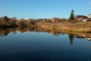 Pond in the village in the autumn morning