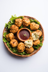 rava Bhajj or bhajiya also known as suji Pakoda or semolina Pakora, served with tomato ketchup. selective focus