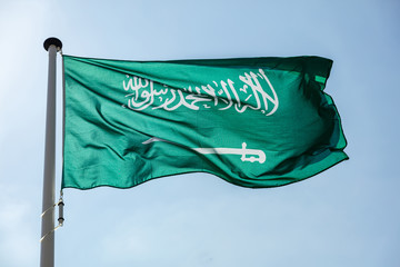 Saudi Arabian flag waving against clear blue sky