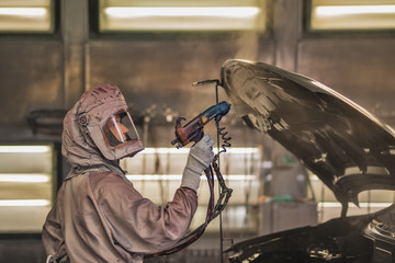 employee body painting workshop carries out painting of the internal elements of the car.
