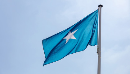 Somalia flag waving against clear blue sky