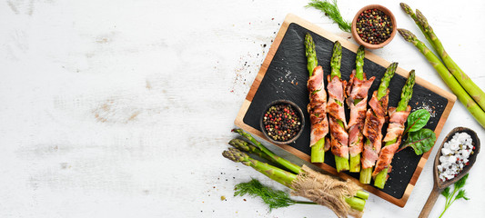 Asparagus baked with bacon and spices. Healthy food. Top view. Free space for your text.