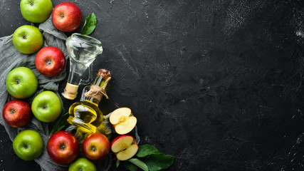 Apples and apple vinegar on the old background. Fruits. Top view. Free space for text.