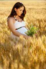 pregnant woman on nature field