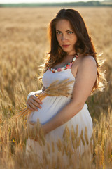 pregnant woman on nature field