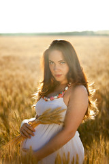 pregnant woman on nature field