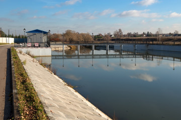 Pedestrian bridge over the dam on an autumn afternoon