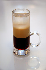 Cocktail B52 shooter with a handle on gray background