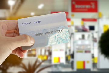 Credit card with mobile phone to make a payment for refueling car on gas station