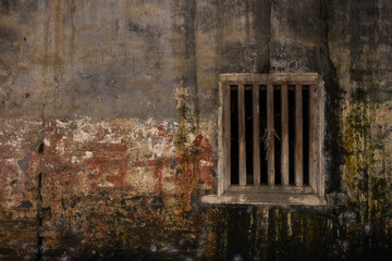 Fototapeta na wymiar Ancient window on the dirty wall in China.
