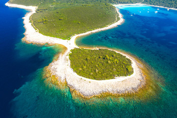 Aerial view of rocky fish shaped cape and sailing boats in a beautiful azure turquoise lagoon on Sakarun beach on Dugi Otok island, Croatia, beautiful seascape