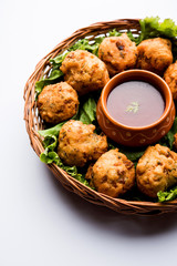 rava Bhajj or bhajiya also known as suji Pakoda or semolina Pakora, served with tomato ketchup. selective focus