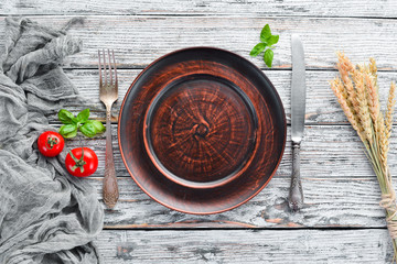 Clay dishes. A plate on a white wooden background. Top view. Free copy space.