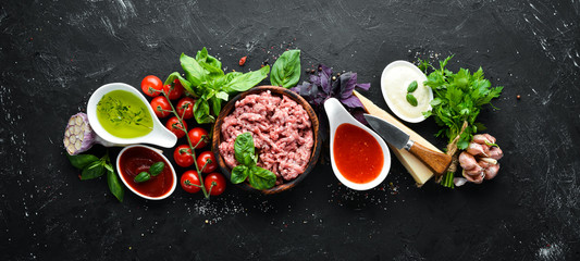 Ingredients for cooking sauce Bolognese. On a black background. Top view. Free space for your text.