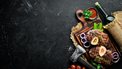 Osso buco cooked Veal shank on a black background. Top view. Free space for your text. - obrazy, fototapety, plakaty