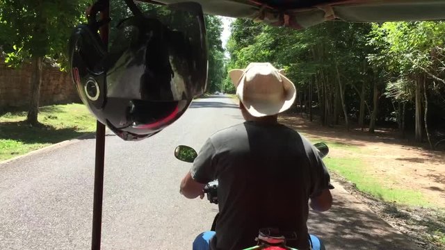 Tuc tuc ride throug the temple roads in Cambodia