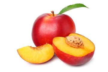 Nectarine with green leaf and slices isolated on white background