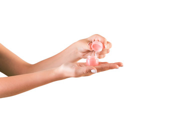 Female hand holding cream bottle of lotion isolated. Girl opening jar cosmetic products on white background