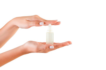 Female hand holding cream bottle of lotion isolated. Girl give tube cosmetic products on white background