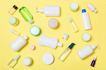 Group of plastic bodycare bottle Flat lay composition with cosmetic products on yellow background...