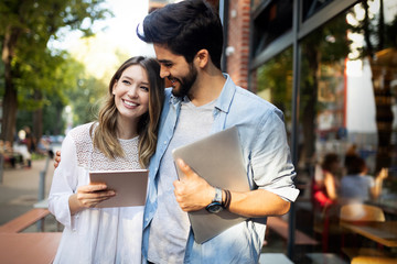 Young couple using a digital tablet together and smiling