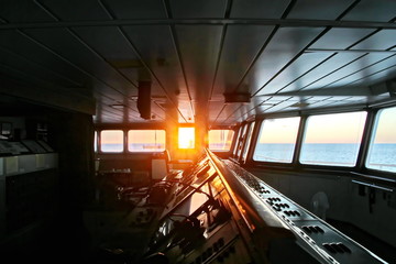 View of the sunset from the ship"s construction and navigational bridge. © masterskuz55